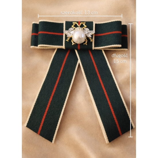 Elegancka broszka w formie kokardy z dekoracyjną perłą – stylowy dodatek inspirowany klasyczną elegancją z wyrazistym charakterem.